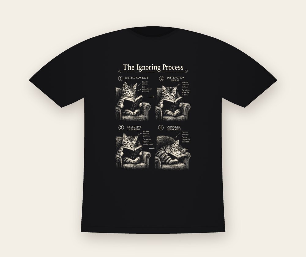Black T-shirt with The Ignoring Process: four engraved panels of a tabby cat reading in an armchair
